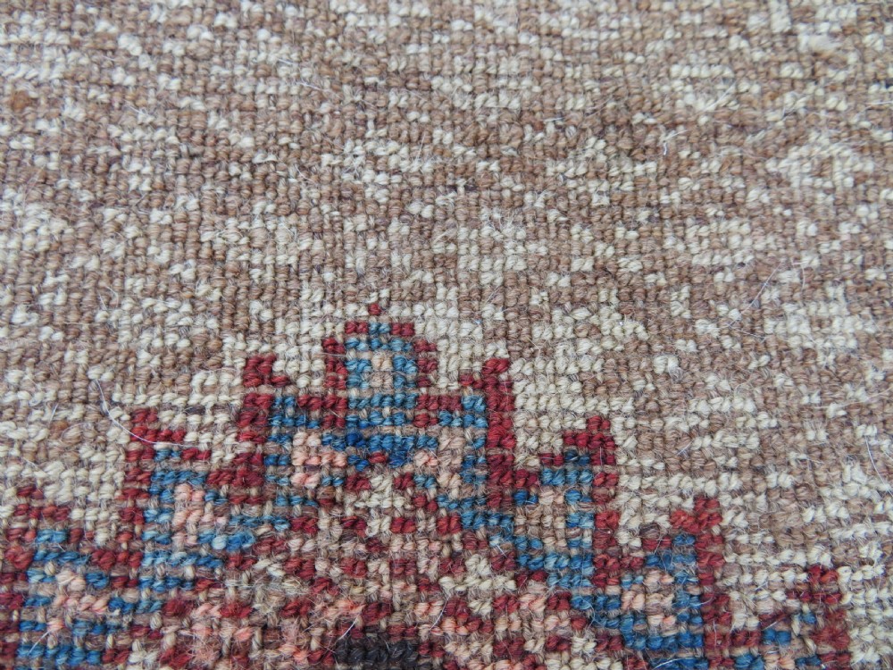 An antique hand-knotted Sarab rug with a geometric central medallion, camel hair field, and distressed terracotta borders. View XVII