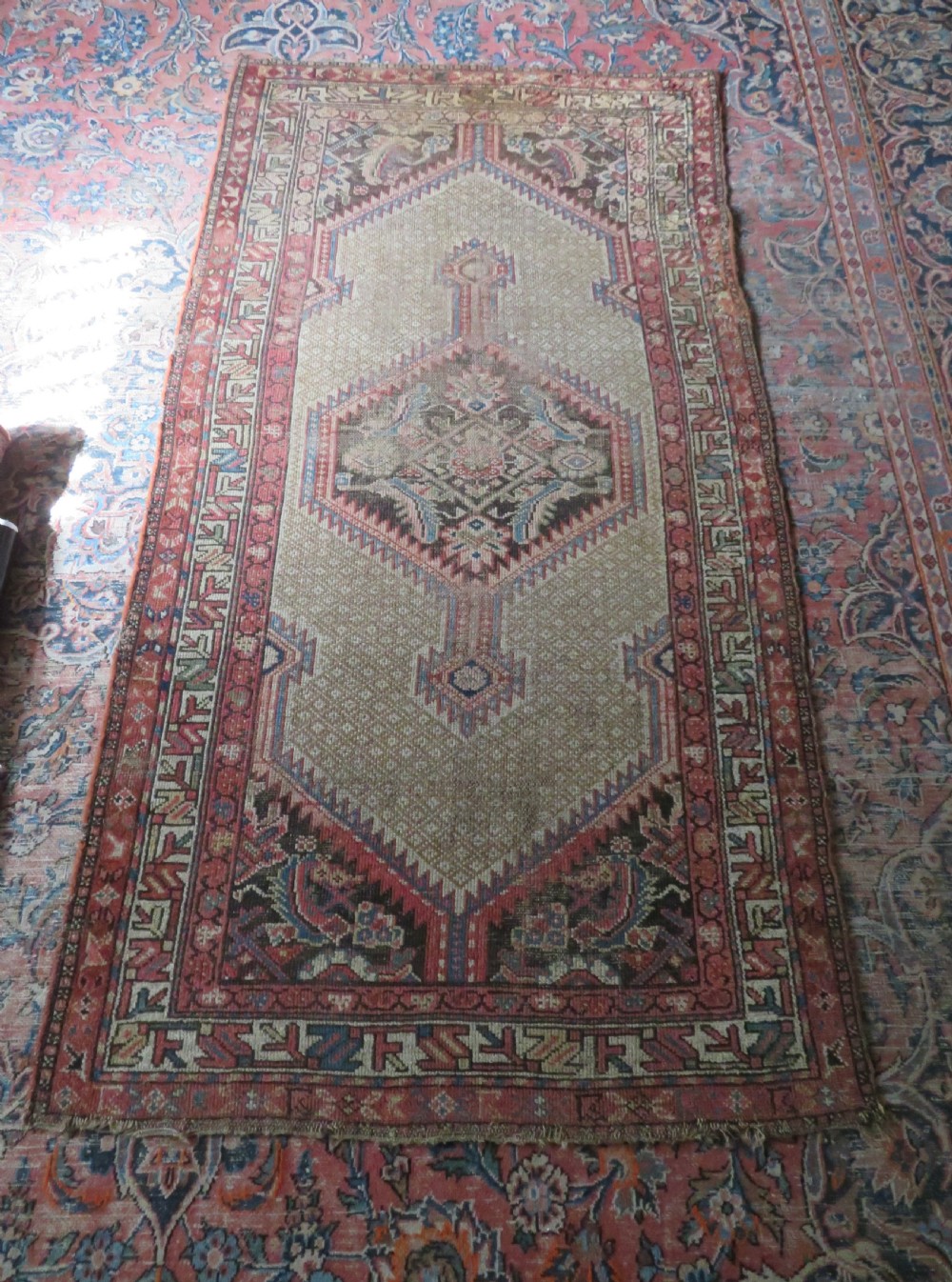 An antique hand-knotted Sarab rug with a geometric central medallion, camel hair field, and distressed terracotta borders. View XVIII
