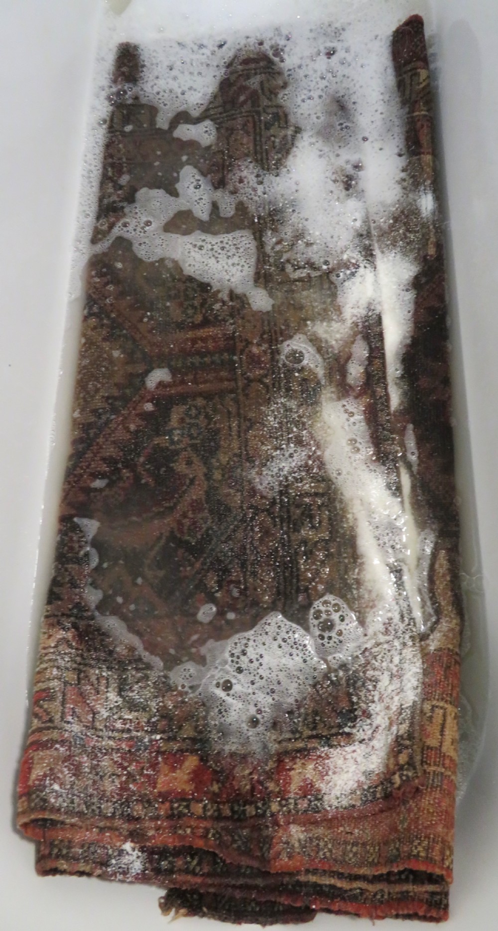 An antique hand-knotted Sarab rug with a geometric central medallion, camel hair field, and distressed terracotta borders. View XX