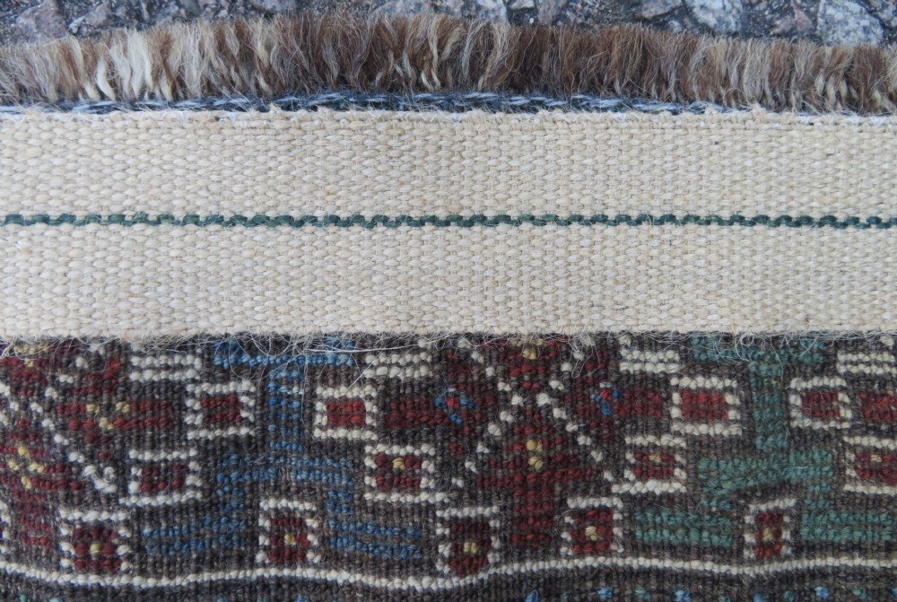 A rectangular hand-knotted antique Khamseh wool rug featuring geometric diamond medallions and intricate border patterns in terracotta, dark brown, and cream. View XXII