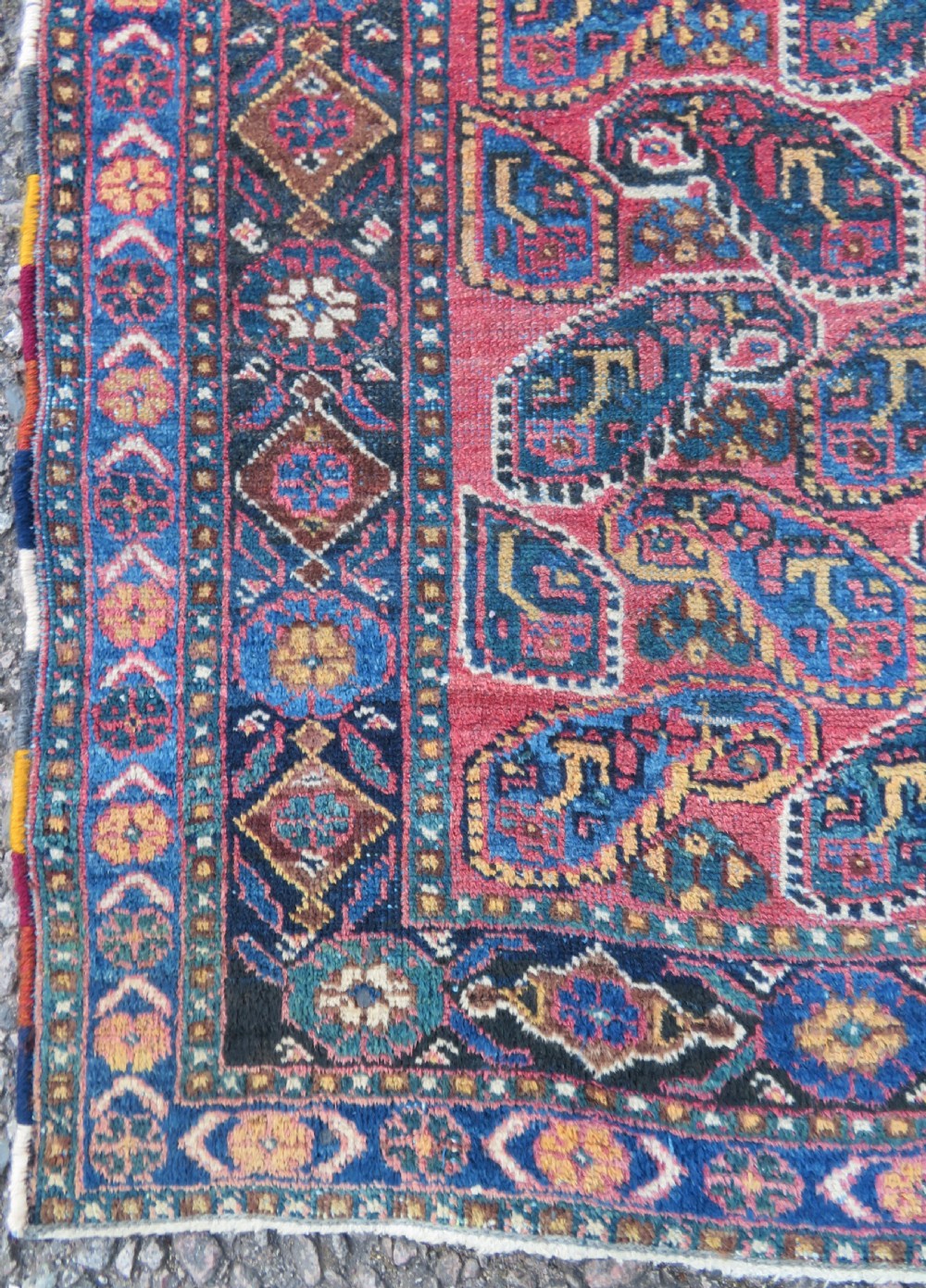 An antique hand-knotted wool Afshar tribal rug featuring a repeating boteh pattern on a terracotta field with geometric blue and cream borders. View VIII