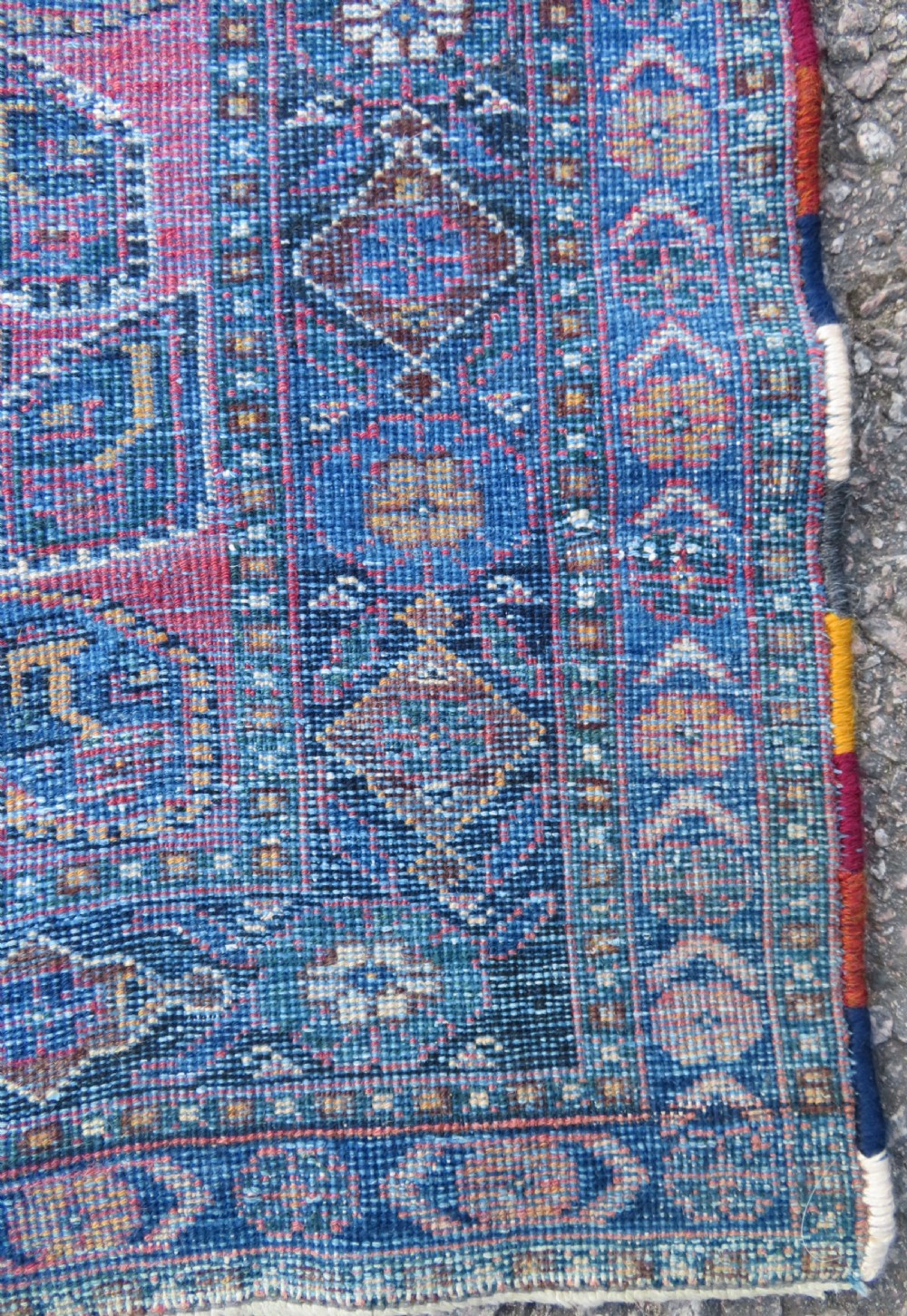 An antique hand-knotted wool Afshar tribal rug featuring a repeating boteh pattern on a terracotta field with geometric blue and cream borders. View XII