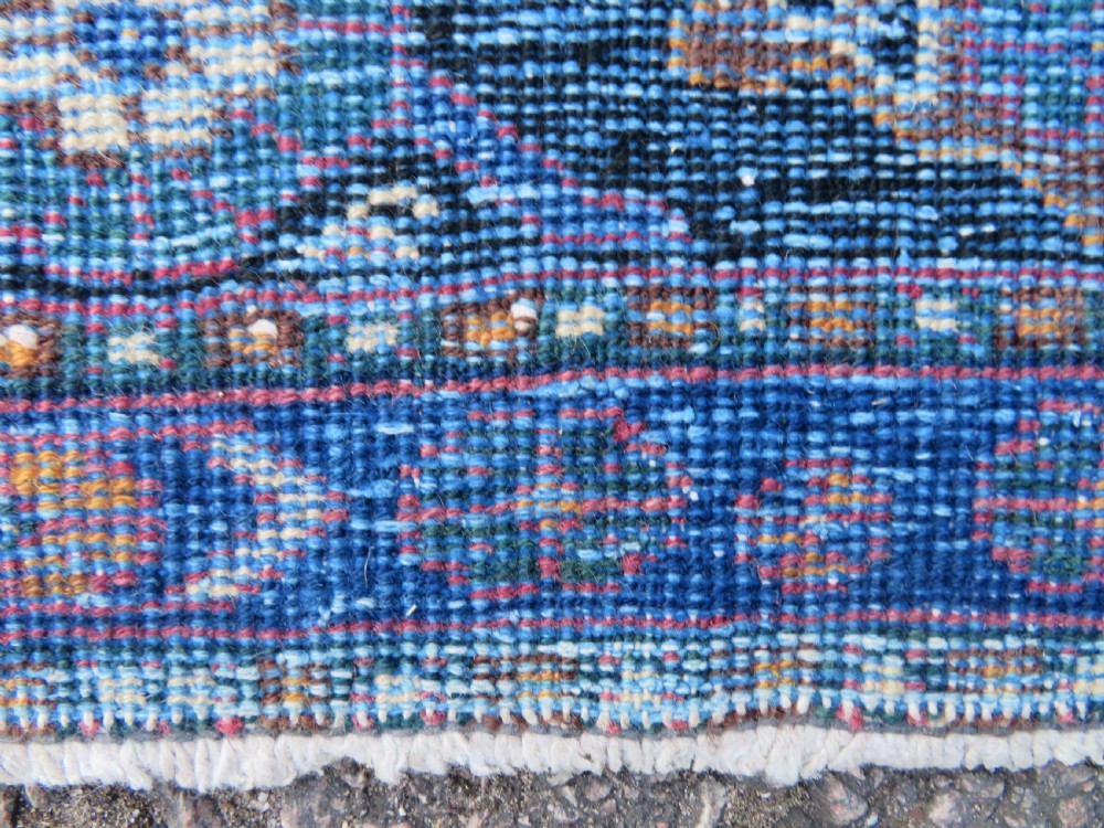 An antique hand-knotted wool Afshar tribal rug featuring a repeating boteh pattern on a terracotta field with geometric blue and cream borders. View XIII