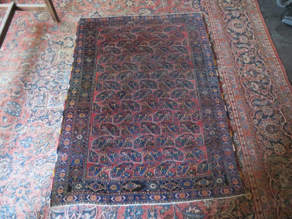An antique hand-knotted wool Afshar tribal rug featuring a repeating boteh pattern on a terracotta field with geometric blue and cream borders. View XV
