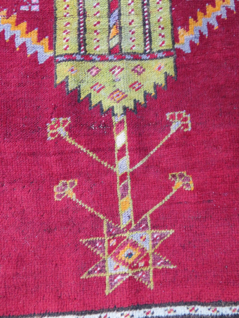 An antique hand-knotted Turkish Kirsehir prayer rug featuring a central red mihrab arch framed by a yellow spandrel and multi-tiered geometric borders. View X