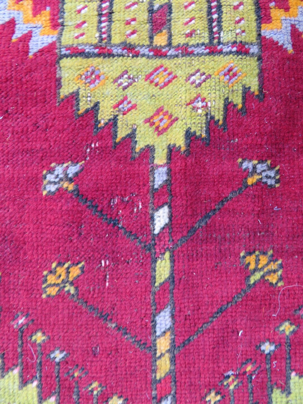 An antique hand-knotted Turkish Kirsehir prayer rug featuring a central red mihrab arch framed by a yellow spandrel and multi-tiered geometric borders. View XI