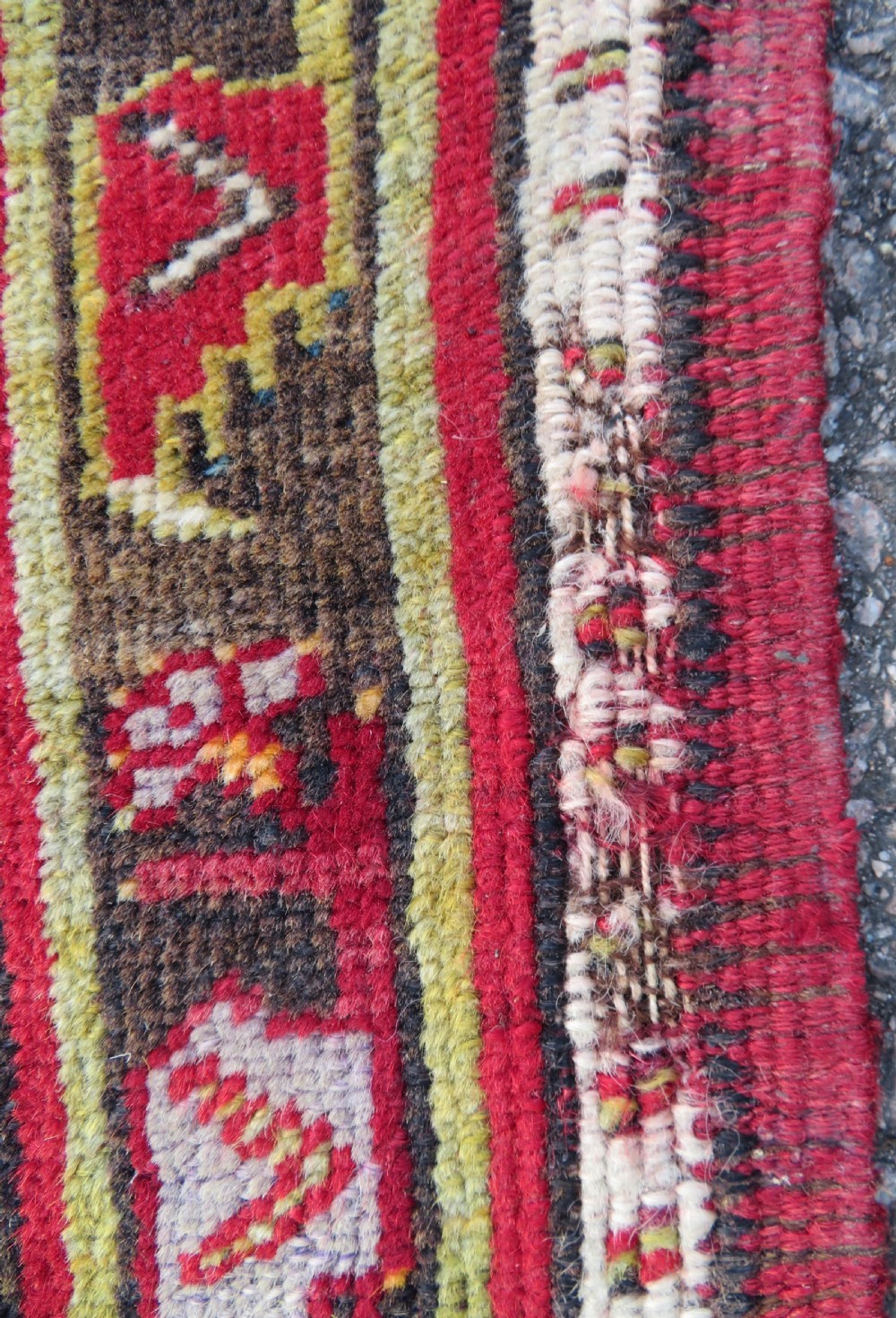 An antique hand-knotted Turkish Kirsehir prayer rug featuring a central red mihrab arch framed by a yellow spandrel and multi-tiered geometric borders. View XII