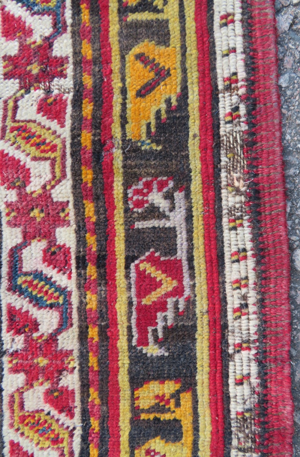 An antique hand-knotted Turkish Kirsehir prayer rug featuring a central red mihrab arch framed by a yellow spandrel and multi-tiered geometric borders. View XIII