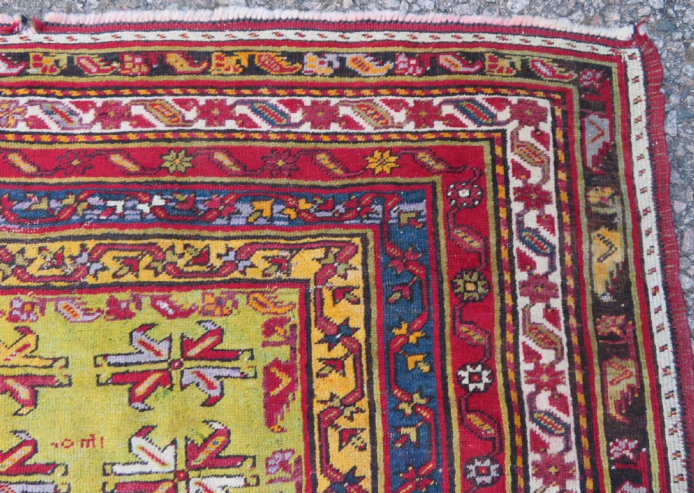 An antique hand-knotted Turkish Kirsehir prayer rug featuring a central red mihrab arch framed by a yellow spandrel and multi-tiered geometric borders. View XIV