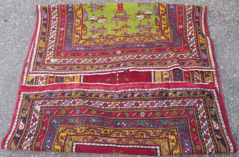An antique hand-knotted Turkish Kirsehir prayer rug featuring a central red mihrab arch framed by a yellow spandrel and multi-tiered geometric borders. View XVI