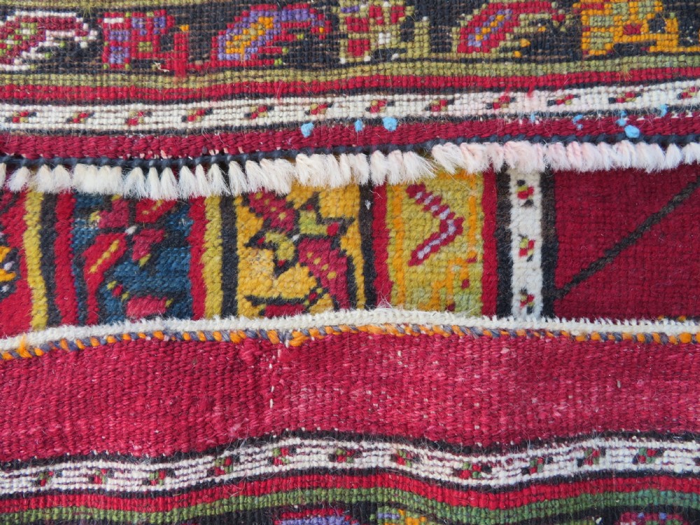 An antique hand-knotted Turkish Kirsehir prayer rug featuring a central red mihrab arch framed by a yellow spandrel and multi-tiered geometric borders. View XVII