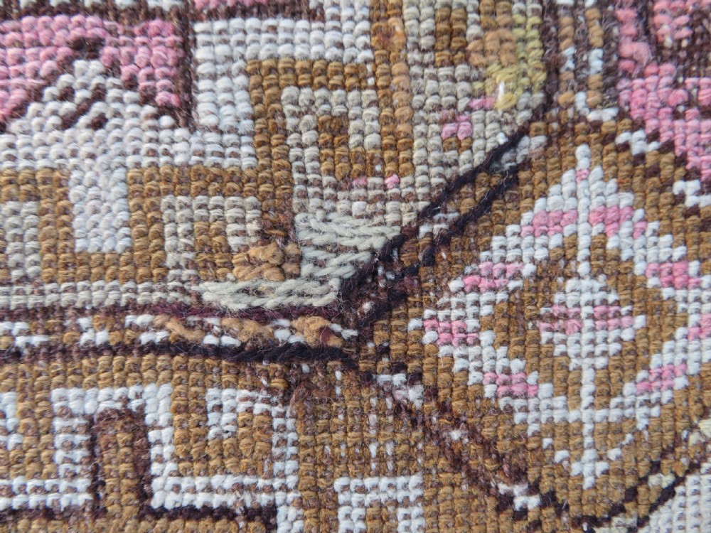 An antique Kurdish hand-knotted wool rug runner featuring repeated geometric octagonal medallions in shades of pink, tan, cream, and dark brown. View VIII