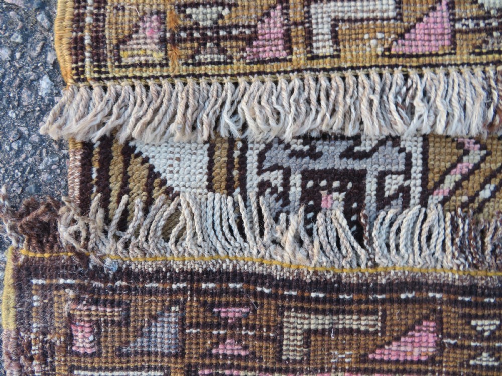 An antique Kurdish hand-knotted wool rug runner featuring repeated geometric octagonal medallions in shades of pink, tan, cream, and dark brown. View XI