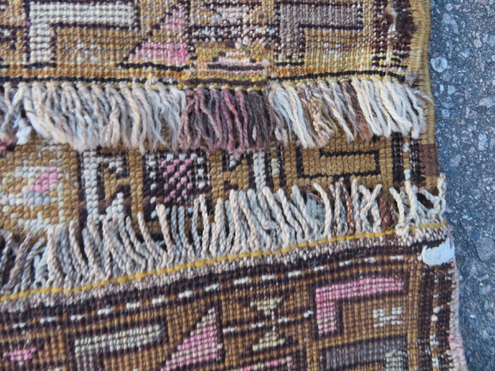 An antique Kurdish hand-knotted wool rug runner featuring repeated geometric octagonal medallions in shades of pink, tan, cream, and dark brown. View XII