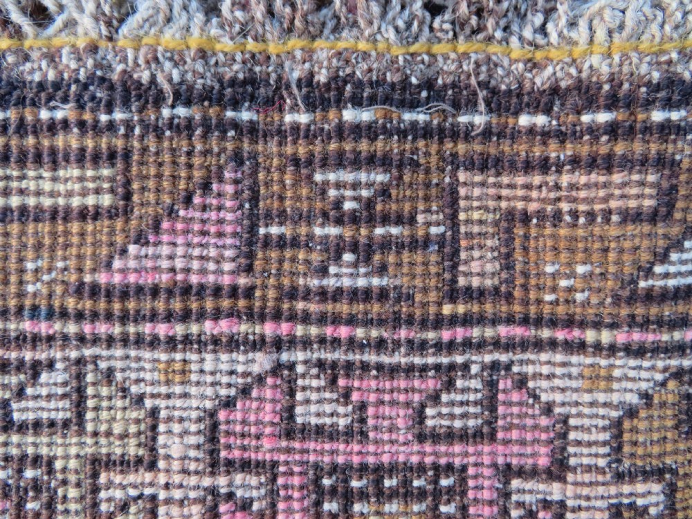 An antique Kurdish hand-knotted wool rug runner featuring repeated geometric octagonal medallions in shades of pink, tan, cream, and dark brown. View XIII