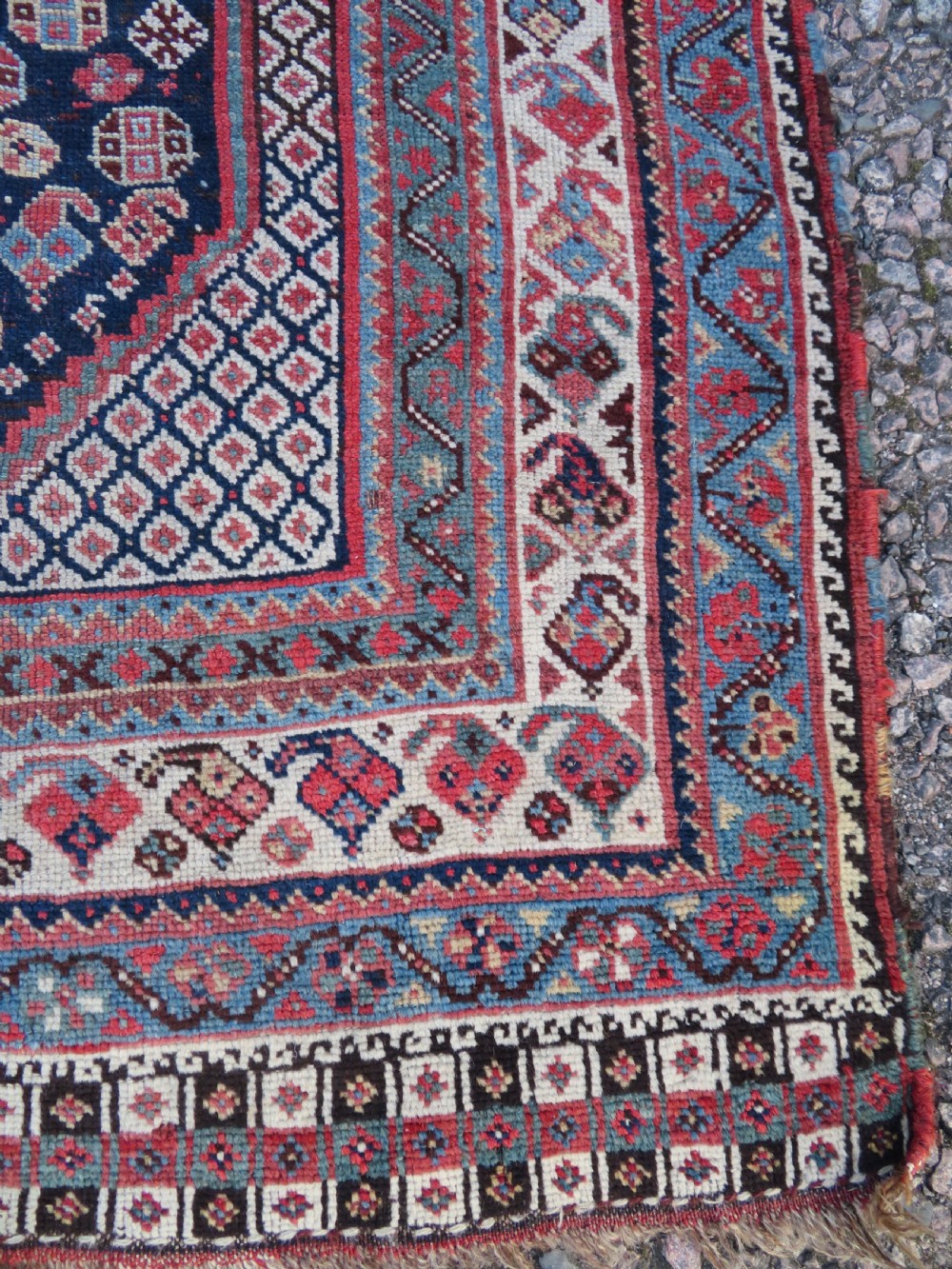 An antique hand-knotted Persian Khamseh carpet featuring three central diamond pole medallions on a dark navy blue field filled with geometric tribal bird and flower motifs surrounded by intricate decorative borders. View XI