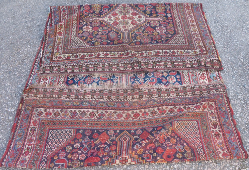 An antique hand-knotted Persian Khamseh carpet featuring three central diamond pole medallions on a dark navy blue field filled with geometric tribal bird and flower motifs surrounded by intricate decorative borders. View XXII