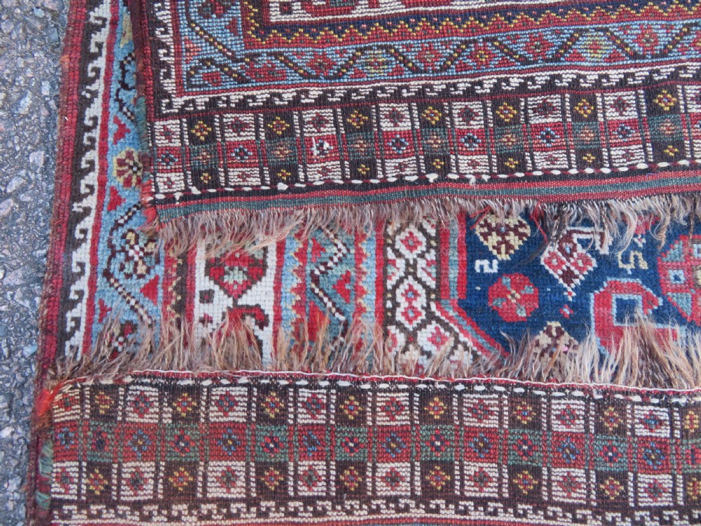 An antique hand-knotted Persian Khamseh carpet featuring three central diamond pole medallions on a dark navy blue field filled with geometric tribal bird and flower motifs surrounded by intricate decorative borders. View XXIII