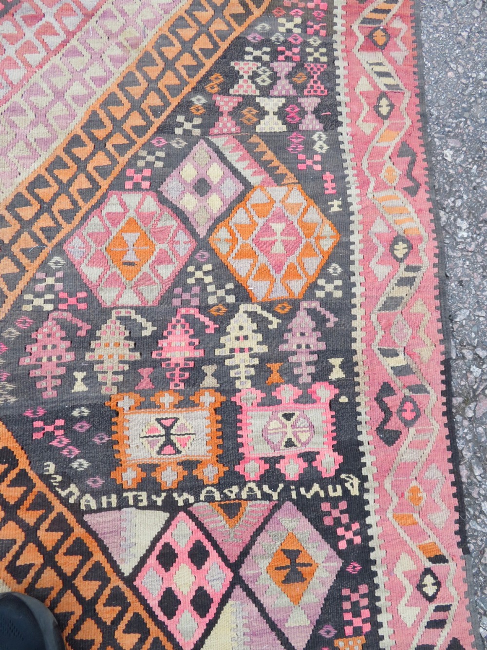 An antique flatwoven Turkish kilim rug featuring central diamond medallions and geometric borders in shades of pink, terracotta, cream, and dark brown. View VIII