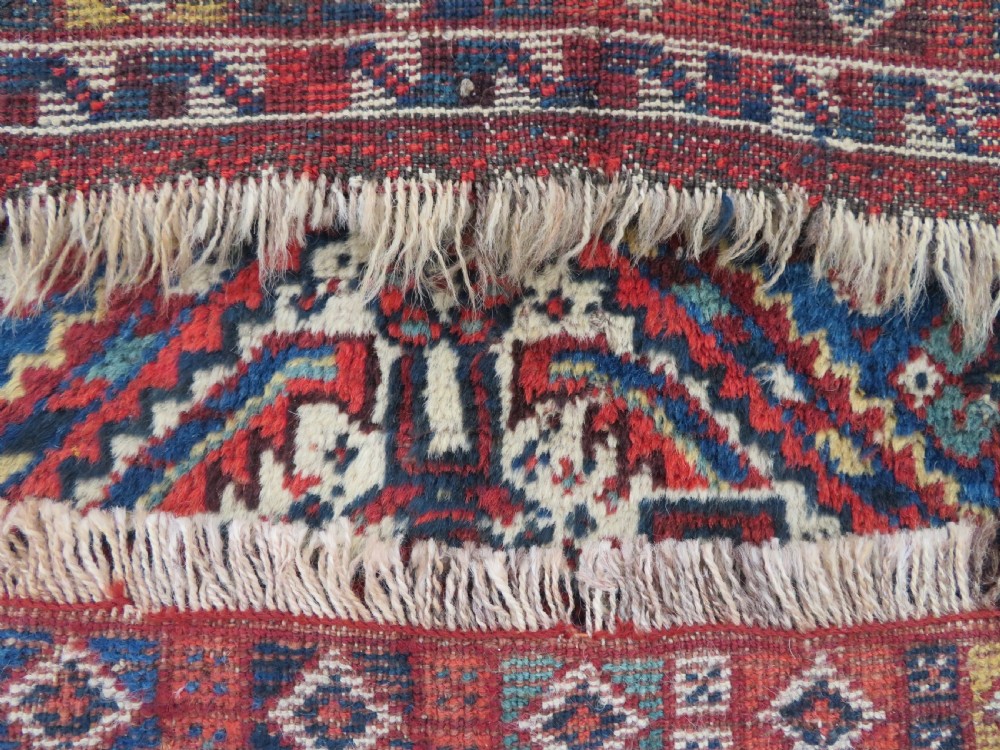 An antique South Persian Khamseh rug featuring three diamond-shaped central medallions and geometric bird motifs in shades of red, navy blue, and cream. View XIV