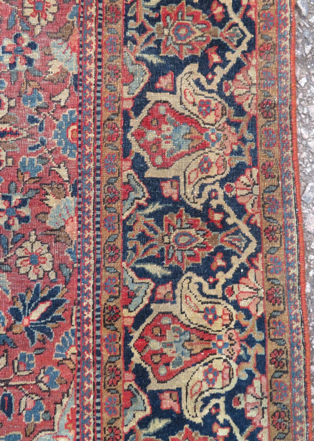 A rectangular hand-knotted wool Kashan rug featuring a central starburst medallion surrounded by dense floral patterns on a terracotta field with a navy border. View VIII