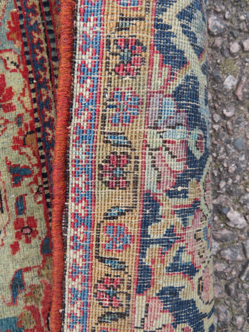 A rectangular hand-knotted wool Kashan rug featuring a central starburst medallion surrounded by dense floral patterns on a terracotta field with a navy border. View IX