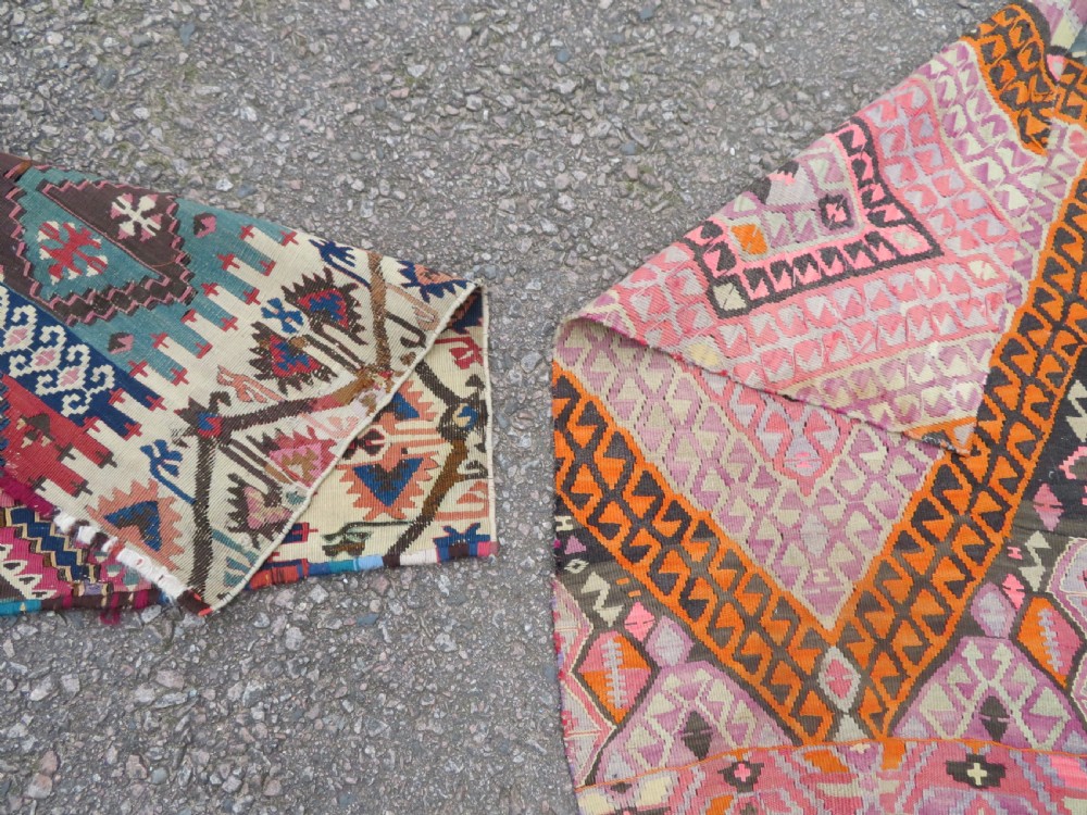 A group of four individual hand-woven Turkish kilim mats featuring vibrant geometric patterns, diamond medallions, and zig-zag borders. View VIII