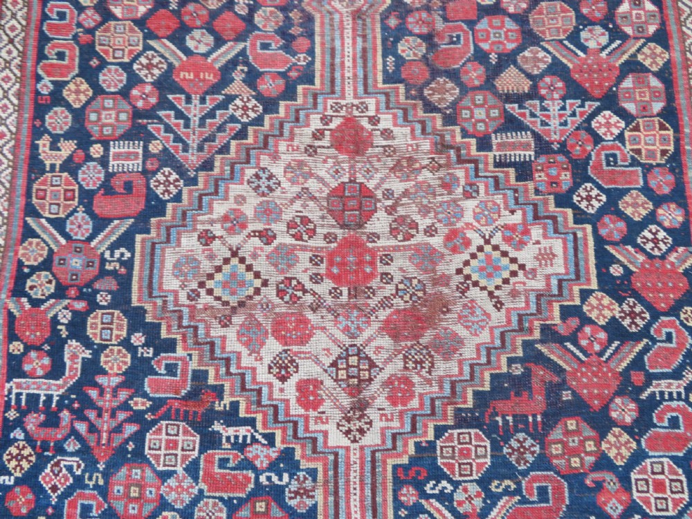An antique hand-knotted Khamseh tribal wool rug featuring three geometric pole medallions in navy blue, terracotta red, and cream with detailed borders. View VI