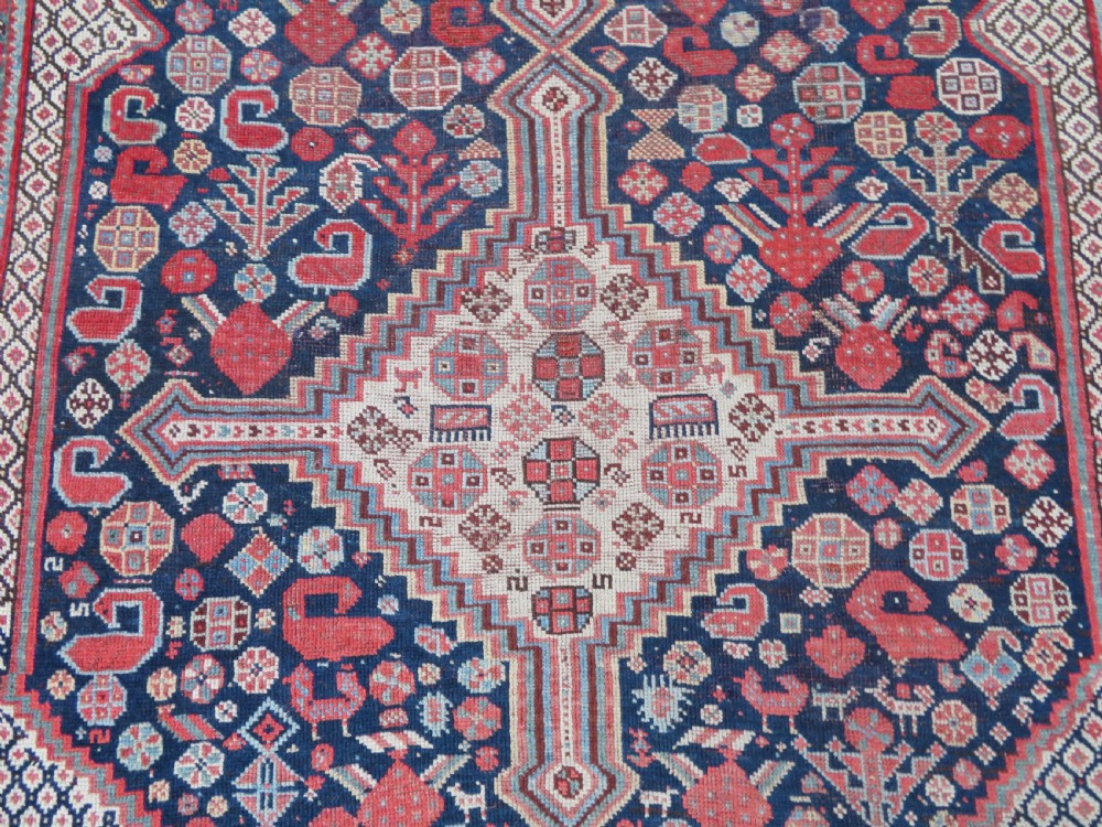 An antique hand-knotted Khamseh tribal wool rug featuring three geometric pole medallions in navy blue, terracotta red, and cream with detailed borders. View VII