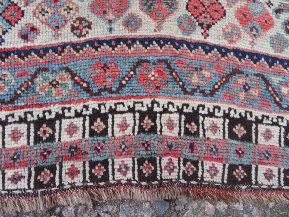 An antique hand-knotted Khamseh tribal wool rug featuring three geometric pole medallions in navy blue, terracotta red, and cream with detailed borders. View IX