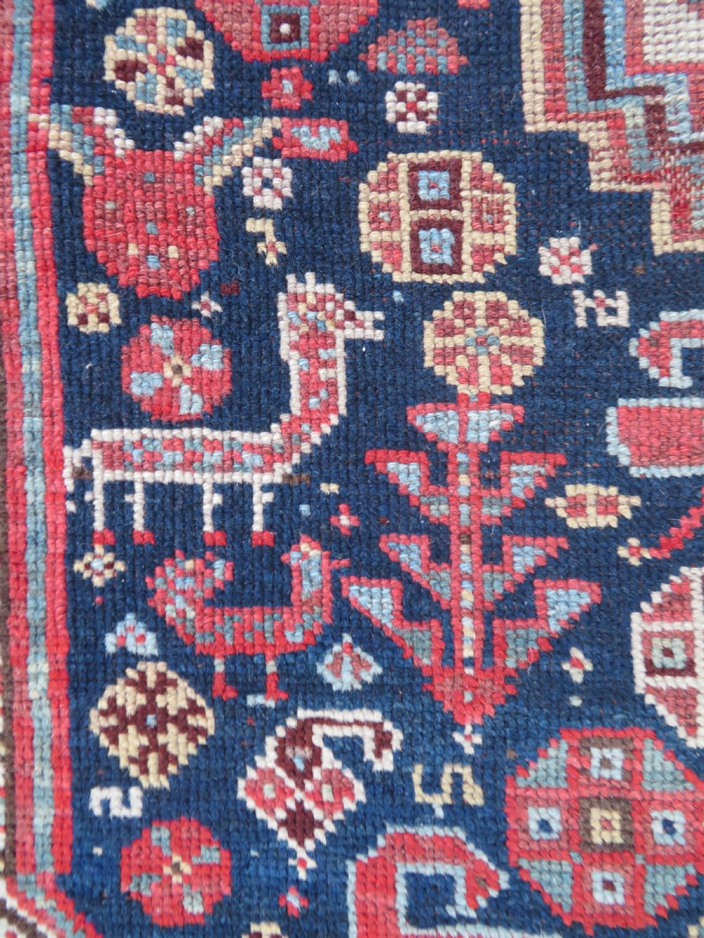 An antique hand-knotted Khamseh tribal wool rug featuring three geometric pole medallions in navy blue, terracotta red, and cream with detailed borders. View XI