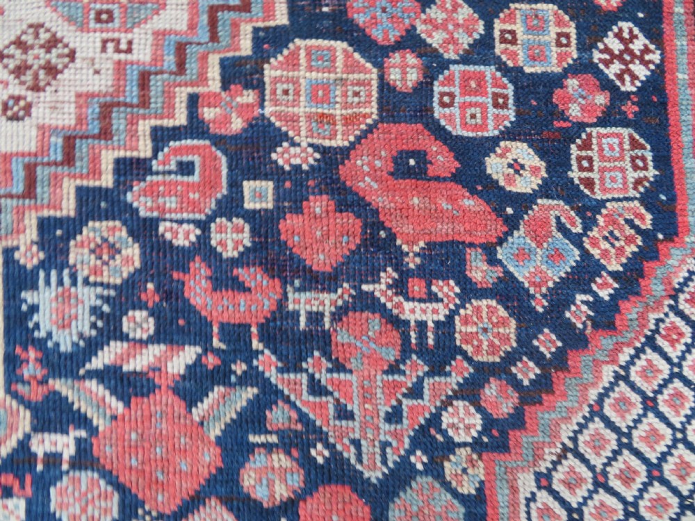 An antique hand-knotted Khamseh tribal wool rug featuring three geometric pole medallions in navy blue, terracotta red, and cream with detailed borders. View XII