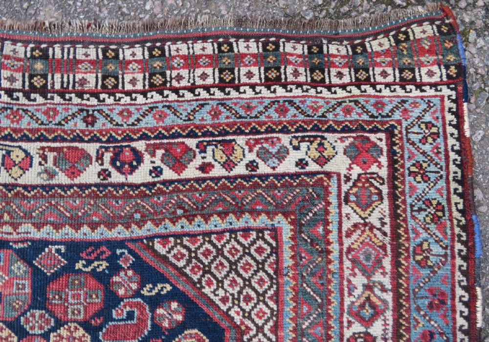 An antique hand-knotted Khamseh tribal wool rug featuring three geometric pole medallions in navy blue, terracotta red, and cream with detailed borders. View XIV