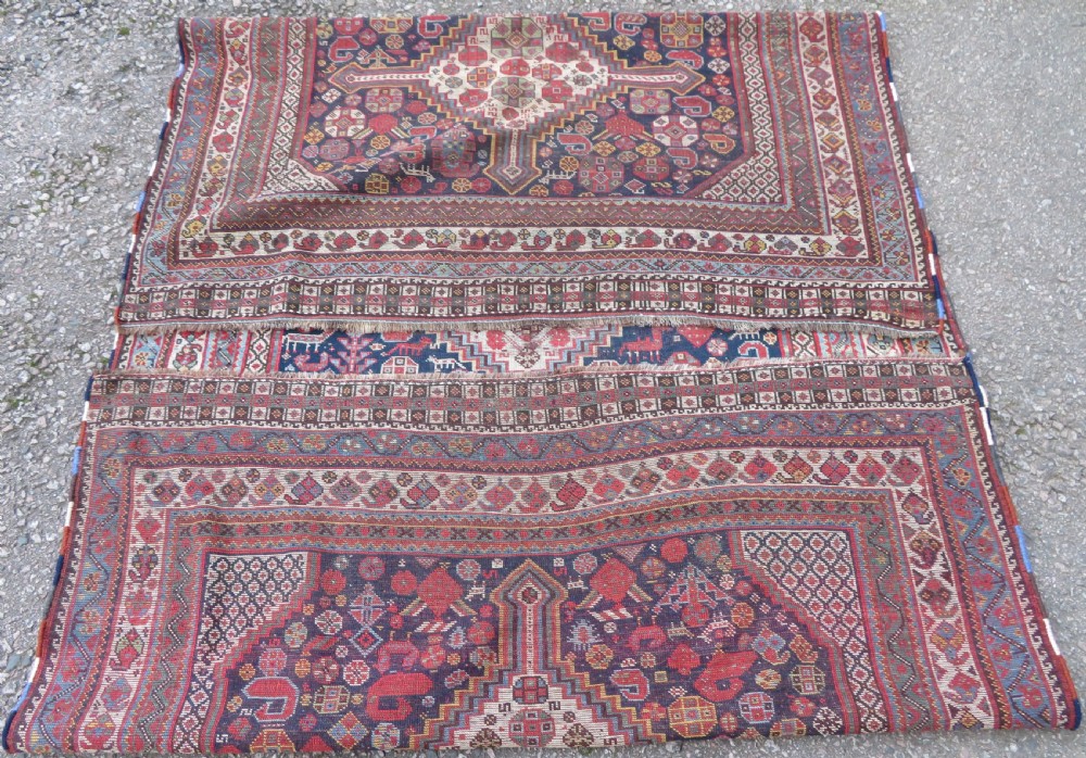 An antique hand-knotted Khamseh tribal wool rug featuring three geometric pole medallions in navy blue, terracotta red, and cream with detailed borders. View XIX