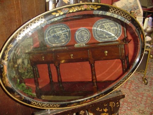 Black Lacquered Oval Mirror. C 1930.