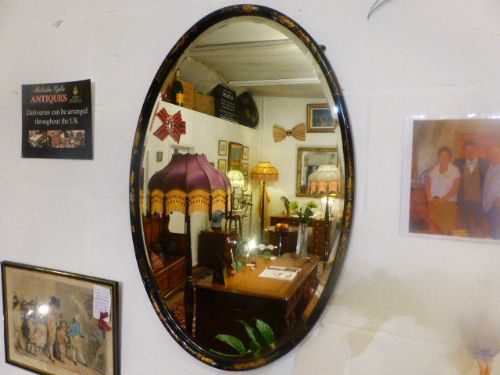 Late 19th Century Oval Bevelled Lacquered Mirror with Chinoiserie Design.