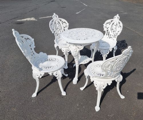 HEAVY CASTIRON SET OF GARDEN TABLE AND FOUR CHAIRS