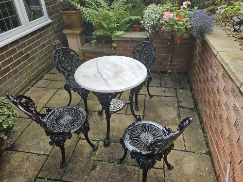 HEAVY CASTIRON SET OF GARDEN TABLE AND FOUR CHAIRS
