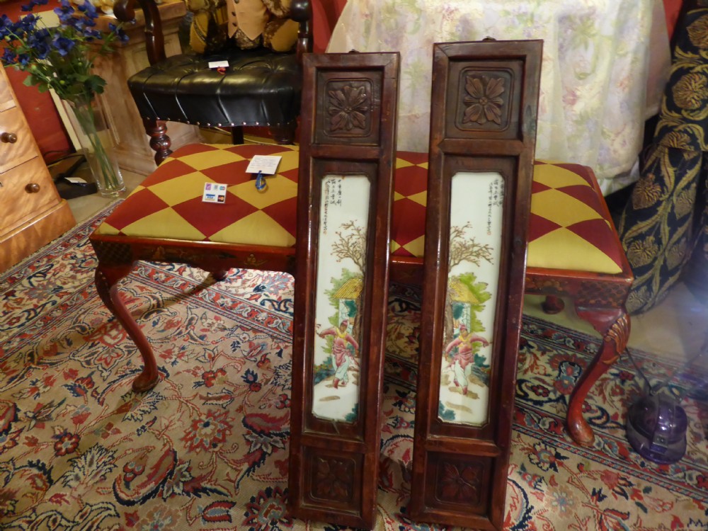 A pair of Chinese wall plaques mounted in hardwood frames