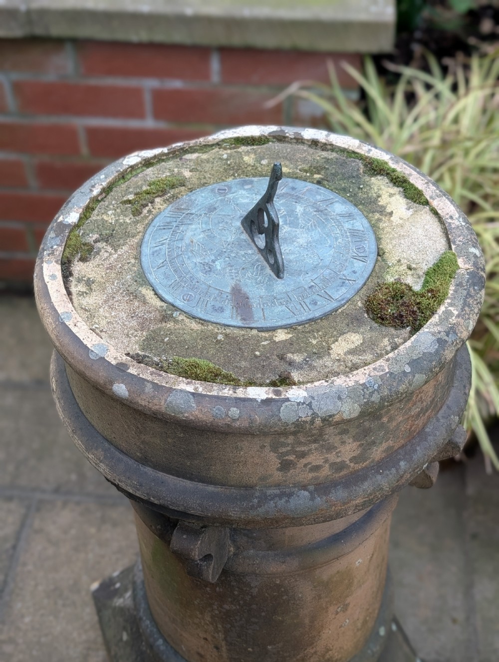 A nineteenth-century Victorian terracotta chimney pot repurposed as a garden sundial with a circular lead dial and gnomon. View III