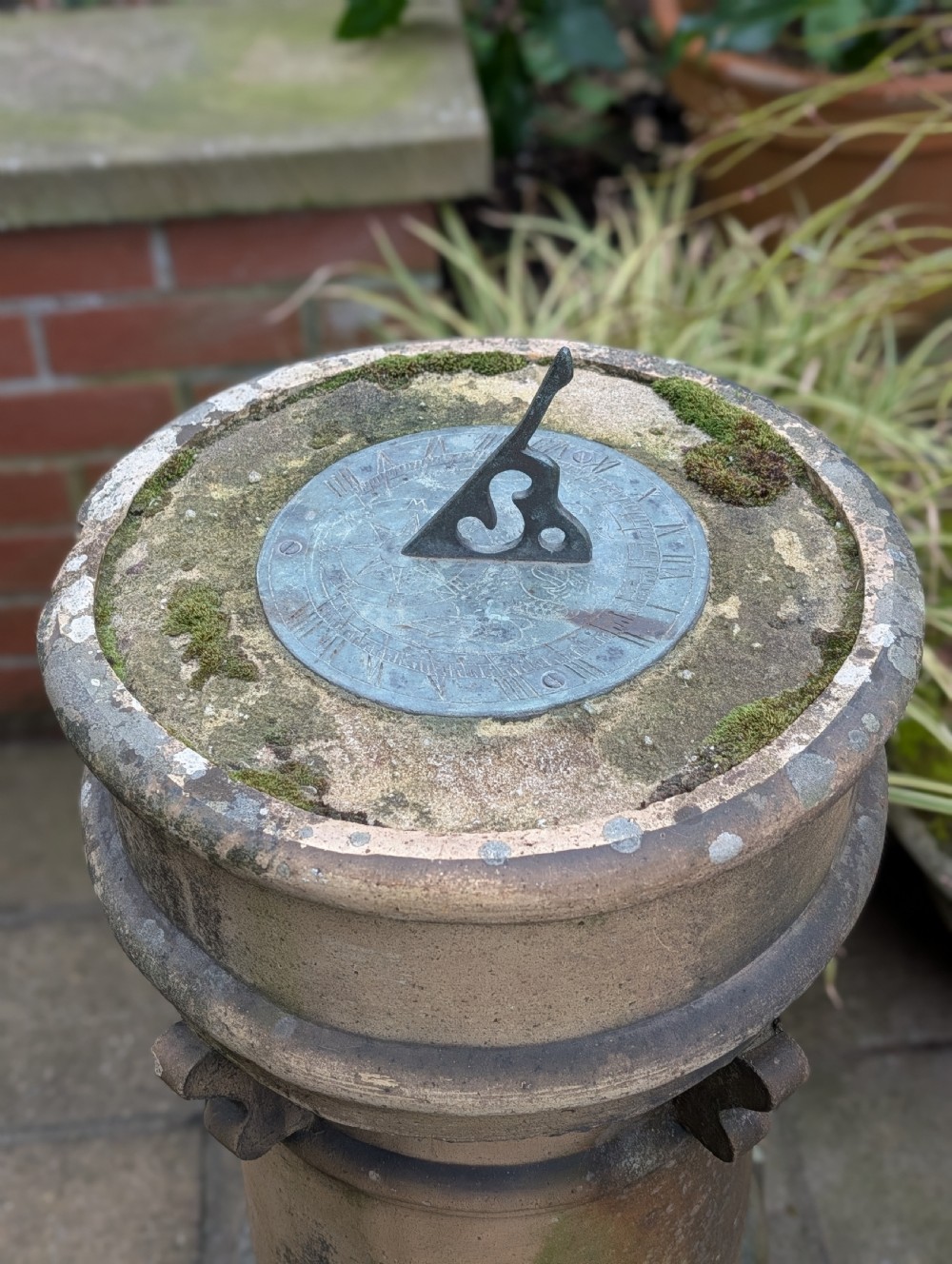 A nineteenth-century Victorian terracotta chimney pot repurposed as a garden sundial with a circular lead dial and gnomon. View VIII