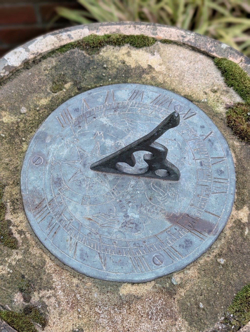 A nineteenth-century Victorian terracotta chimney pot repurposed as a garden sundial with a circular lead dial and gnomon. View IX
