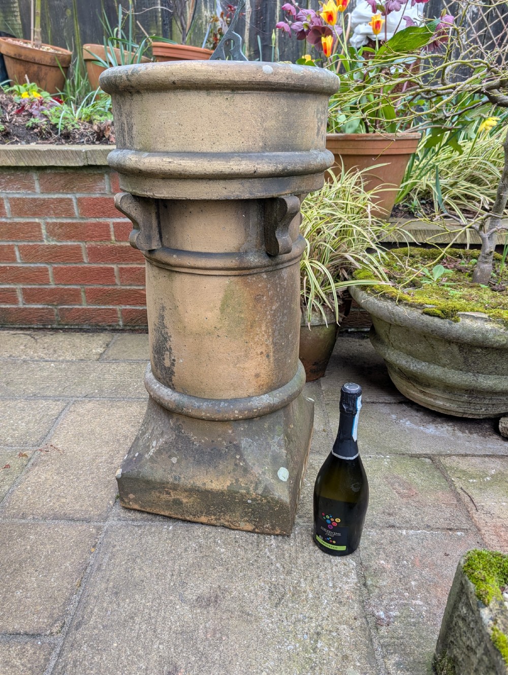 A nineteenth-century Victorian terracotta chimney pot repurposed as a garden sundial with a circular lead dial and gnomon. View X