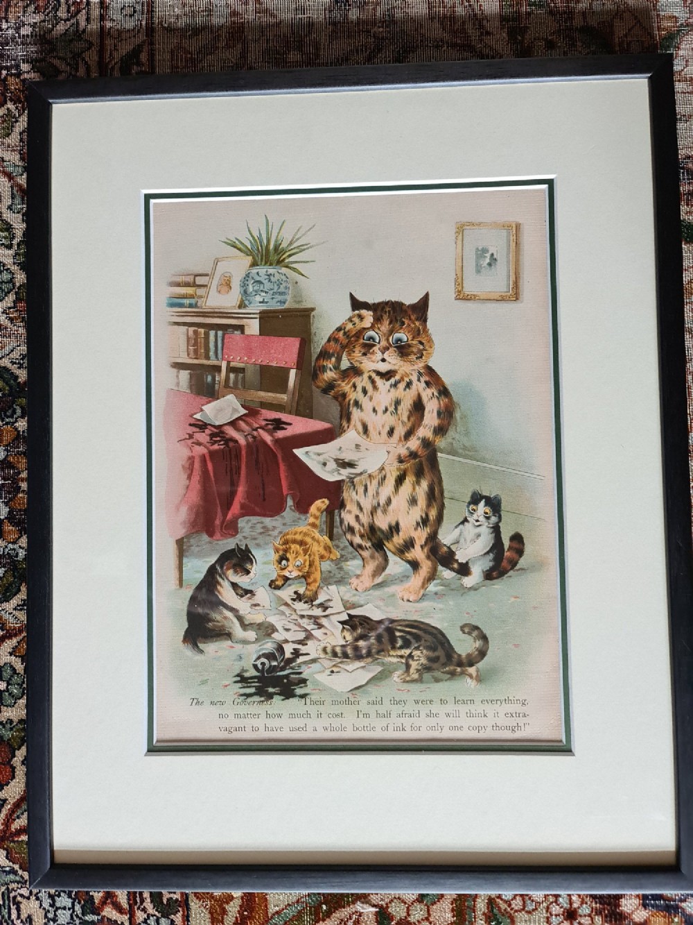 A pair of black framed antique prints depicting anthropomorphic cats in domestic interior scenes with printed text captions. View II