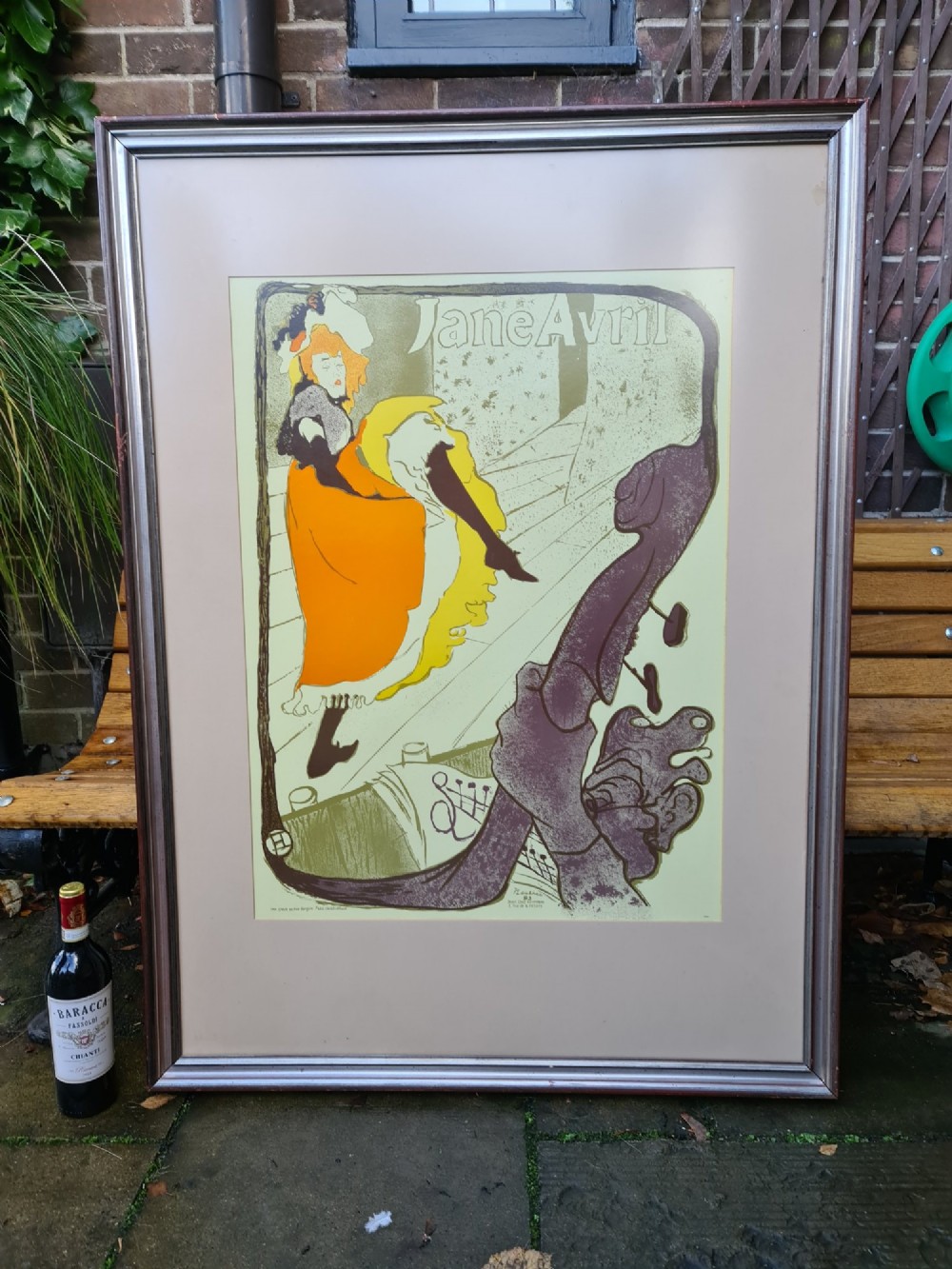 A framed vintage Art Nouveau poster featuring Jane Avril performing in an orange dress framed by a stylised double bass neck. View II