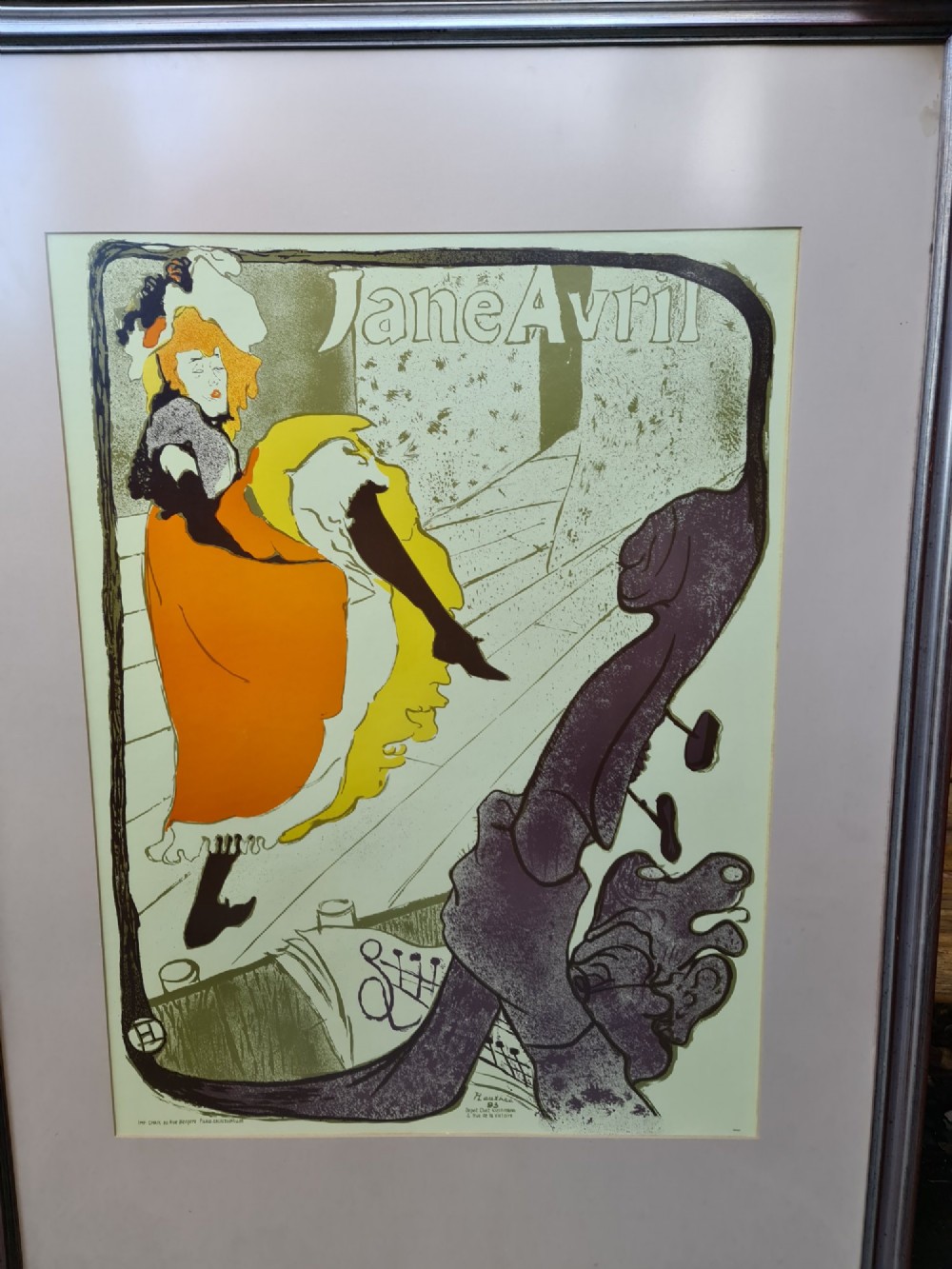 A framed vintage Art Nouveau poster featuring Jane Avril performing in an orange dress framed by a stylised double bass neck. View III