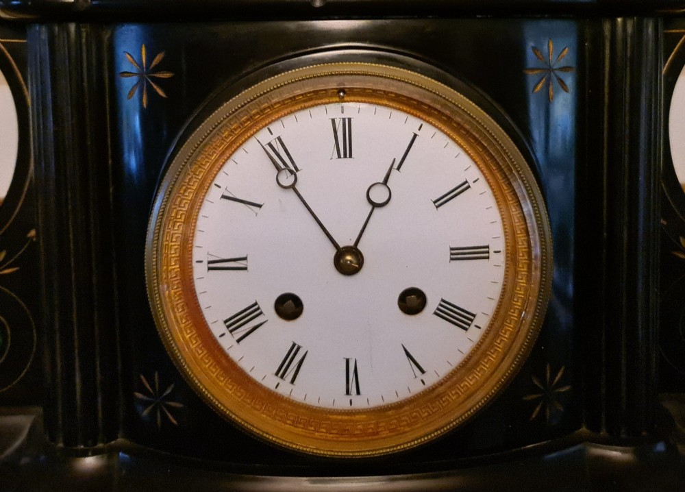 A Victorian black slate mantel clock featuring incised gilt star motifs, green malachite stone inlays, twin fluted columns, and a white enamel dial with Roman numerals. View III