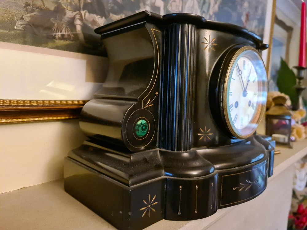 A Victorian black slate mantel clock featuring incised gilt star motifs, green malachite stone inlays, twin fluted columns, and a white enamel dial with Roman numerals. View IV