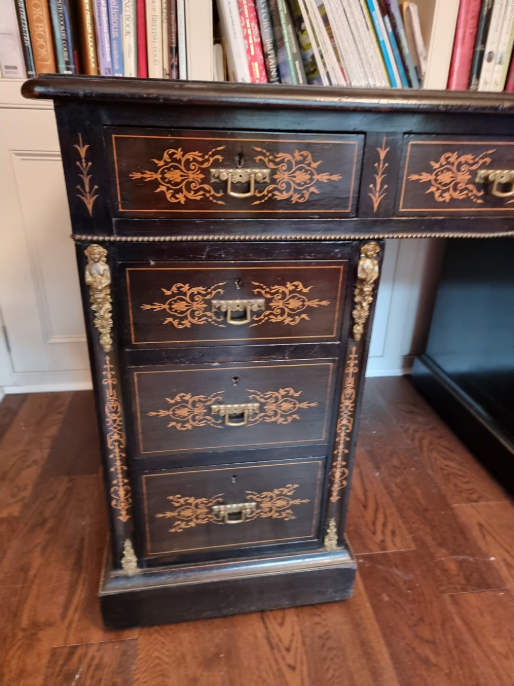 A dark ebonised Victorian pedestal desk featuring detailed floral marquetry inlay, brass handles, ormolu corner mounts, and a leather insert top. View II