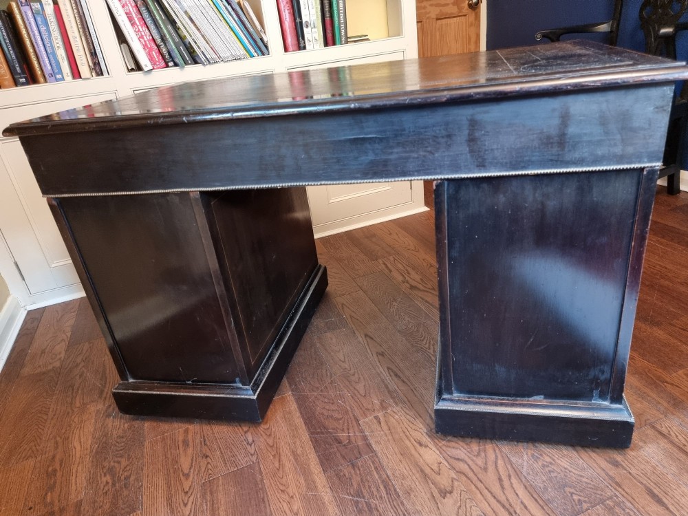 A dark ebonised Victorian pedestal desk featuring detailed floral marquetry inlay, brass handles, ormolu corner mounts, and a leather insert top. View IX